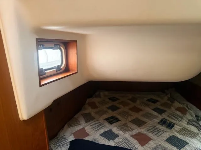 Jet Stream Yacht Photos Pics Cozy cabin interior of 2003 Wauquiez Centurion 45s sailboat with window and patterned bedding.