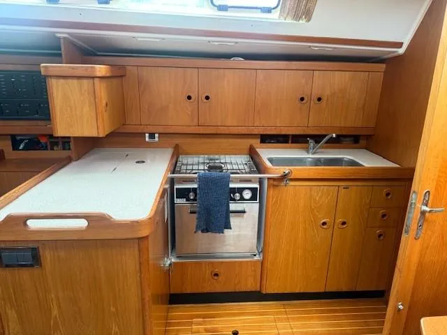 Jet Stream Yacht Photos Pics Interior of 2003 Wauquiez Centurion 45s yacht kitchen with wooden cabinetry and stainless steel appliances.