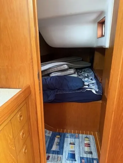 Jet Stream Yacht Photos Pics Cozy cabin interior of 2003 Wauquiez Centurion 45s sailboat with wooden finish and bedding.