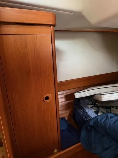 Jet Stream Yacht Photos Pics Interior cabin of 2003 Wauquiez Centurion 45s with wooden cabinetry and bedding.