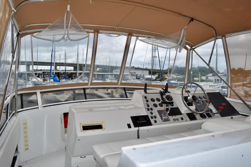 Sweet Freedom Yacht Photos Pics 1999 Carver 406 Aft Cabin Motor Yacht helm with marina view, featuring navigation controls.