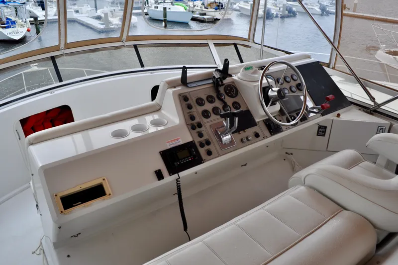Sweet Freedom Yacht Photos Pics 1999 Carver 406 Aft Cabin Motor Yacht helm with steering wheel and control panel.