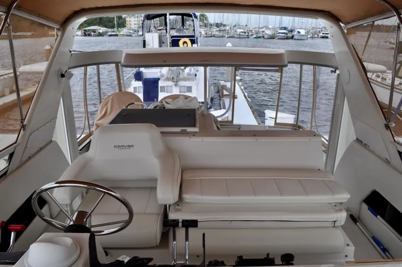 Sweet Freedom Yacht Photos Pics 1999 Carver 406 Aft Cabin Motor Yacht interior with helm and seating, docked at marina.