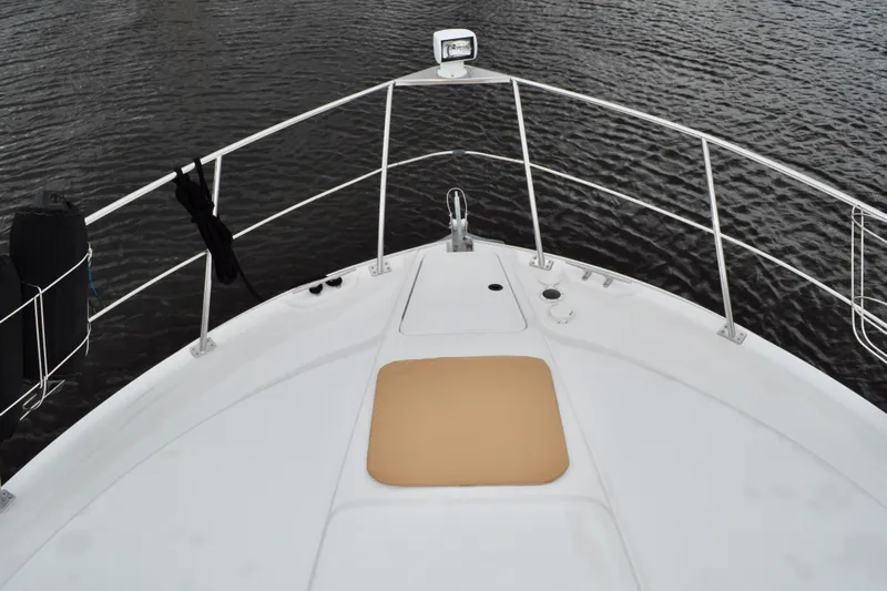 Sweet Freedom Yacht Photos Pics 1999 Carver 406 Aft Cabin Motor Yacht bow view on calm water.