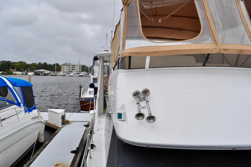 Sweet Freedom Yacht Photos Pics 1999 Carver 406 Aft Cabin Motor Yacht docked at marina on cloudy day.