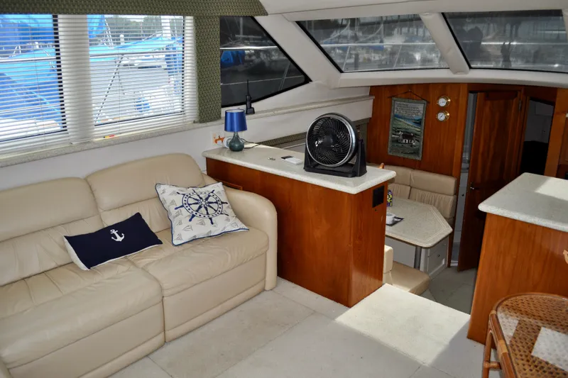 Sweet Freedom Yacht Photos Pics Interior of 1999 Carver 406 Aft Cabin Motor Yacht with cozy seating and nautical decor.