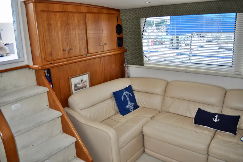 Sweet Freedom Yacht Photos Pics 1999 Carver 406 Aft Cabin Motor Yacht interior with beige leather sofa and nautical decor.