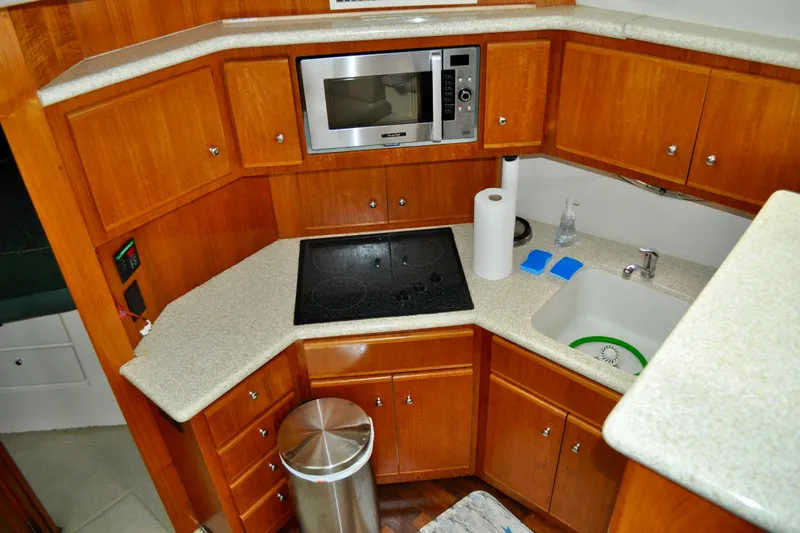 Sweet Freedom Yacht Photos Pics 1999 Carver 406 Aft Cabin Motor Yacht kitchen with microwave, stove, and sink.