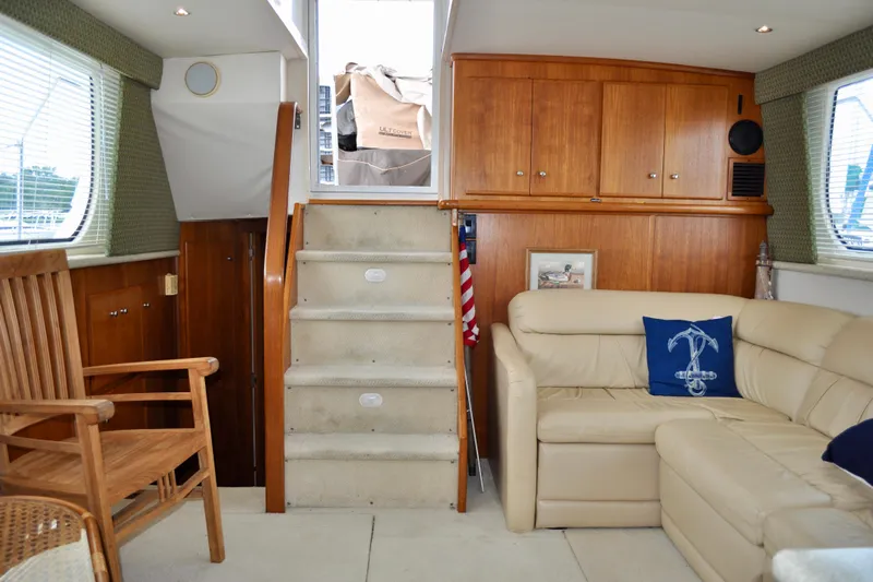 Sweet Freedom Yacht Photos Pics Interior of 1999 Carver 406 Aft Cabin Motor Yacht with beige seating and wooden accents.