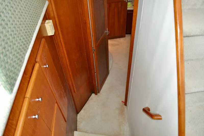 Sweet Freedom Yacht Photos Pics Interior hallway of 1999 Carver 406 Aft Cabin Motor Yacht with wooden cabinetry.