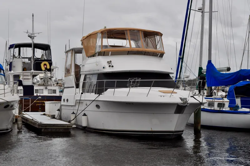 Sweet Freedom Yacht Photos Pics 1999 Carver 406 Aft Cabin Motor Yacht docked at marina, surrounded by other boats.