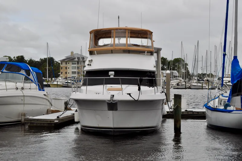 Sweet Freedom Yacht Photos Pics 1999 Carver 406 Aft Cabin Motor Yacht docked at marina, surrounded by sailboats.