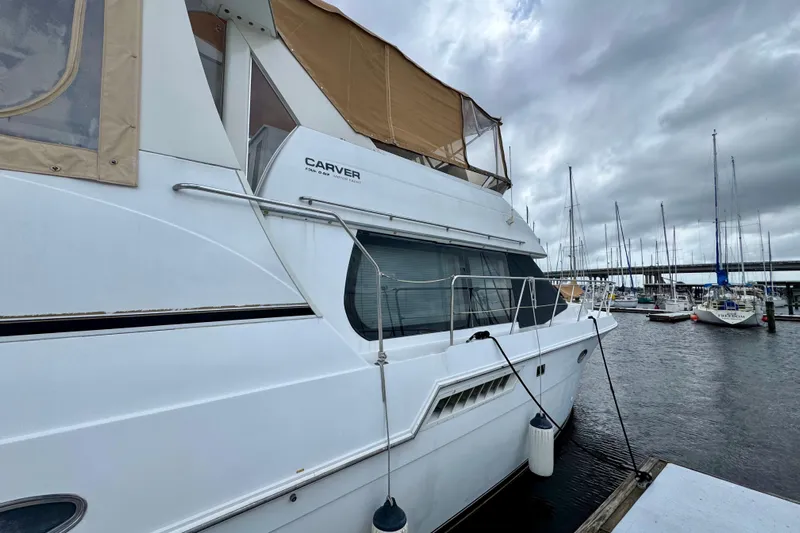 Sweet Freedom Yacht Photos Pics 1999 Carver 406 Aft Cabin Motor Yacht docked at marina under cloudy skies.