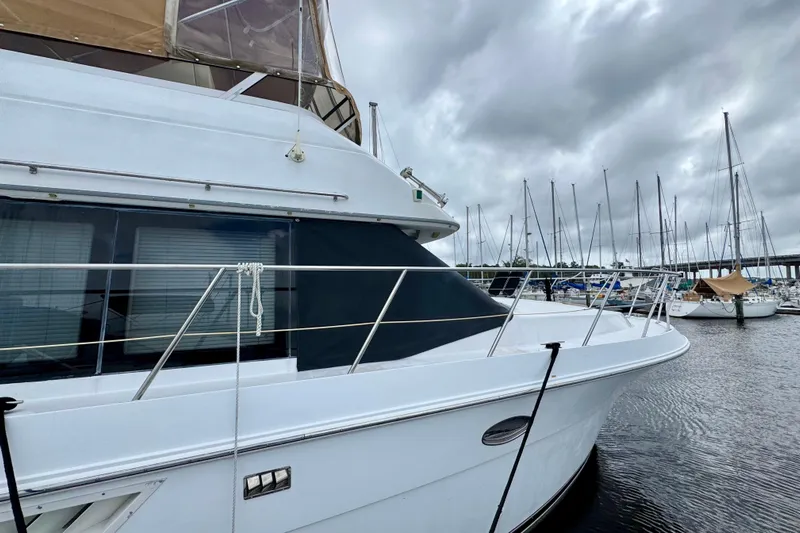 Sweet Freedom Yacht Photos Pics 1999 Carver 406 Aft Cabin Motor Yacht docked at marina under cloudy skies.