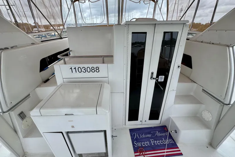 Sweet Freedom Yacht Photos Pics 1999 Carver 406 Aft Cabin Motor Yacht interior with welcome mat and seating area.