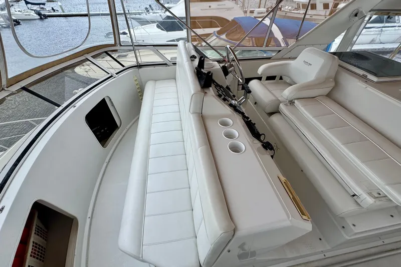 Sweet Freedom Yacht Photos Pics 1999 Carver 406 Aft Cabin Motor Yacht interior with white seating and helm station.