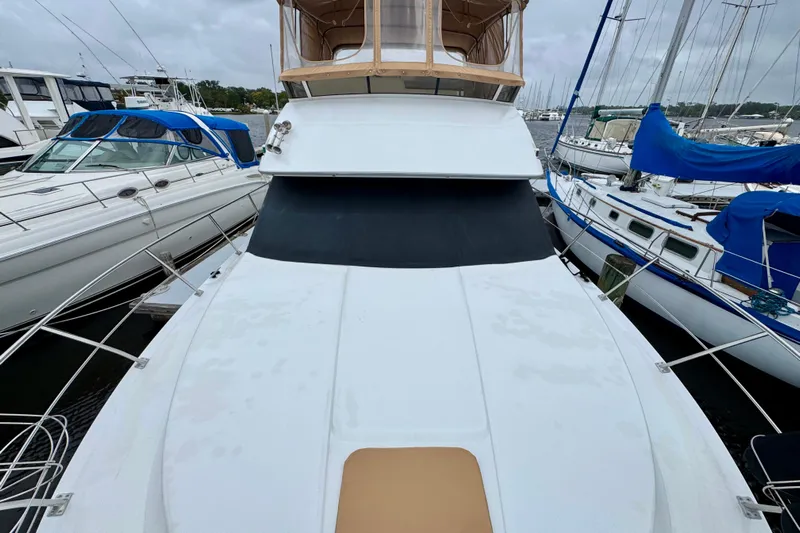 Sweet Freedom Yacht Photos Pics 1999 Carver 406 Aft Cabin Motor Yacht docked among other boats.