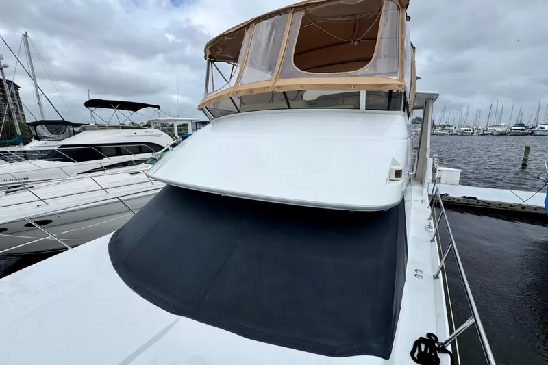 Sweet Freedom Yacht Photos Pics 1999 Carver 406 Aft Cabin Motor Yacht docked at marina, overcast sky.