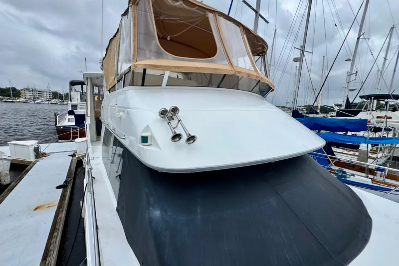 Sweet Freedom Yacht Photos Pics 1999 Carver 406 Aft Cabin Motor Yacht docked at marina, overcast sky.