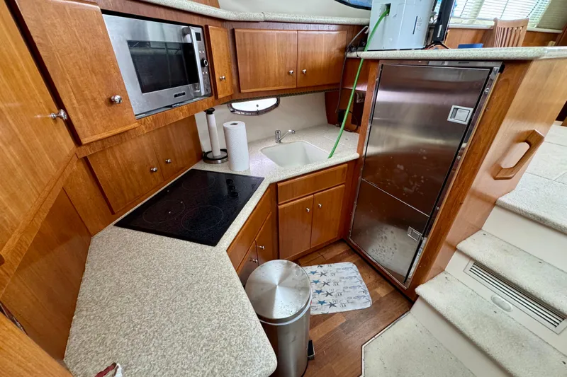 Sweet Freedom Yacht Photos Pics 1999 Carver 406 Aft Cabin Motor Yacht kitchen with wood cabinets and modern appliances.
