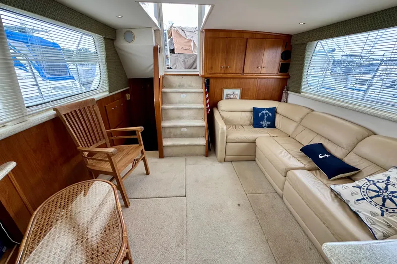 Sweet Freedom Yacht Photos Pics 1999 Carver 406 Aft Cabin Motor Yacht interior with beige seating and wooden accents.