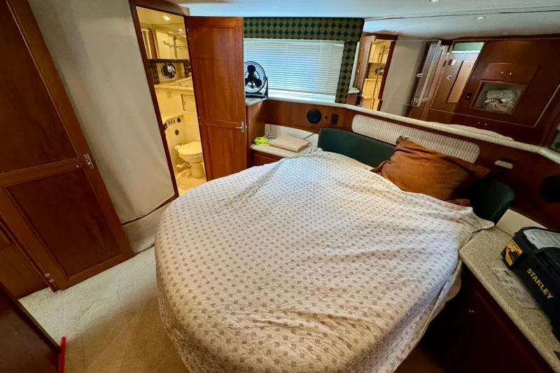 Sweet Freedom Yacht Photos Pics 1999 Carver 406 Aft Cabin Motor Yacht bedroom with cozy bed and ensuite bathroom.