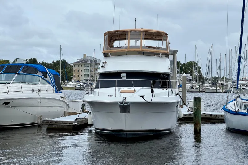 Sweet Freedom Yacht Photos Pics 1999 Carver 406 Aft Cabin Motor Yacht docked at marina, surrounded by other boats.