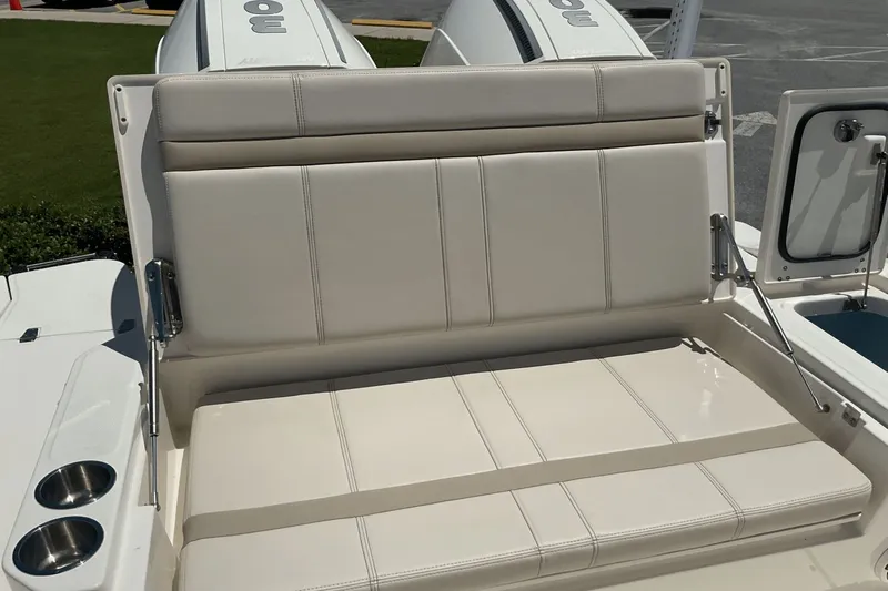  Yacht Photos Pics 2024 Boston Whaler 28 Dauntless boat seating with cup holders and storage compartment.