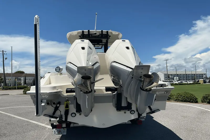  Yacht Photos Pics 2024 Boston Whaler 28 Dauntless boat with dual outboard engines, parked outdoors.