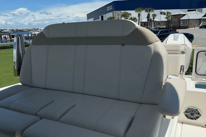  Yacht Photos Pics 2024 Boston Whaler 28 Dauntless boat seat with armrest, dockside view.