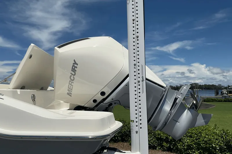  Yacht Photos Pics 2024 Boston Whaler 28 Dauntless with Mercury outboard engine, docked by a scenic waterfront.