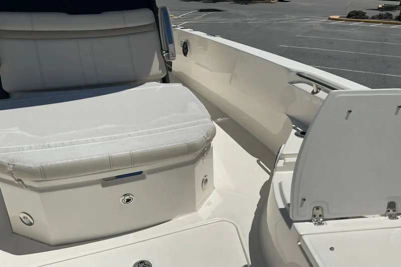  Yacht Photos Pics 2024 Boston Whaler 28 Dauntless boat interior with white seating and storage compartments.