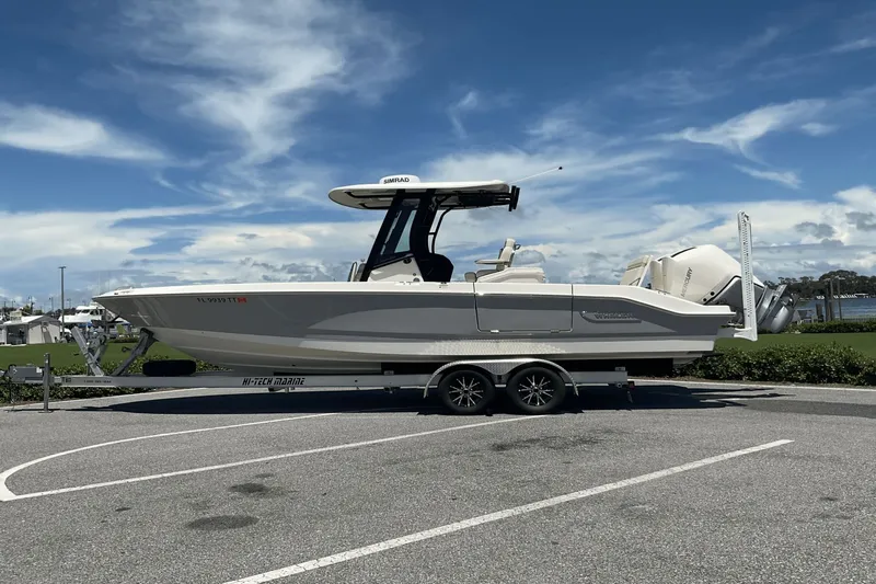  Yacht Photos Pics 2024 Boston Whaler 28 Dauntless boat on trailer under clear sky.