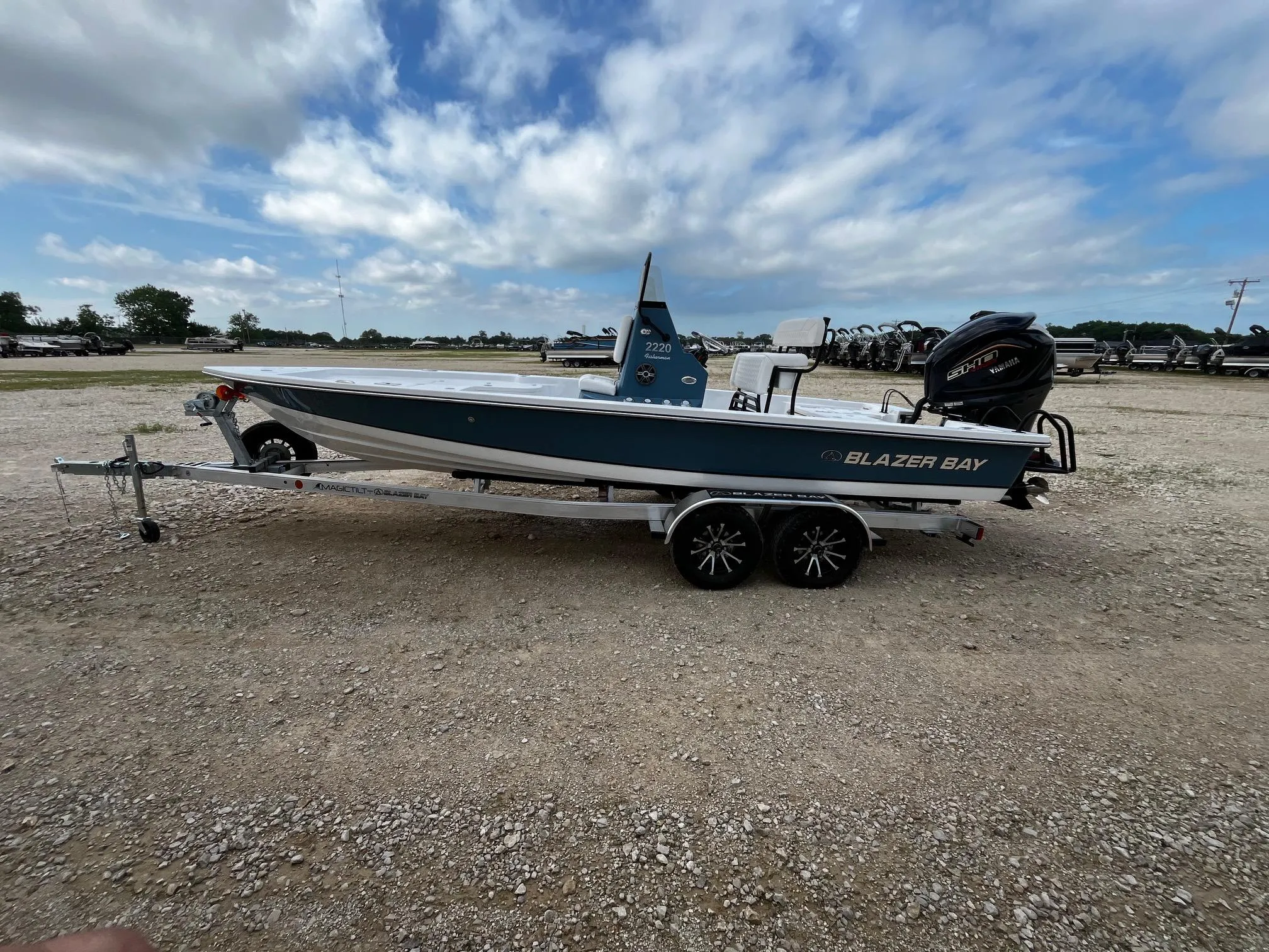 2025 Blazer Bay 2220 Fisherman boat on trailer under cloudy sky.