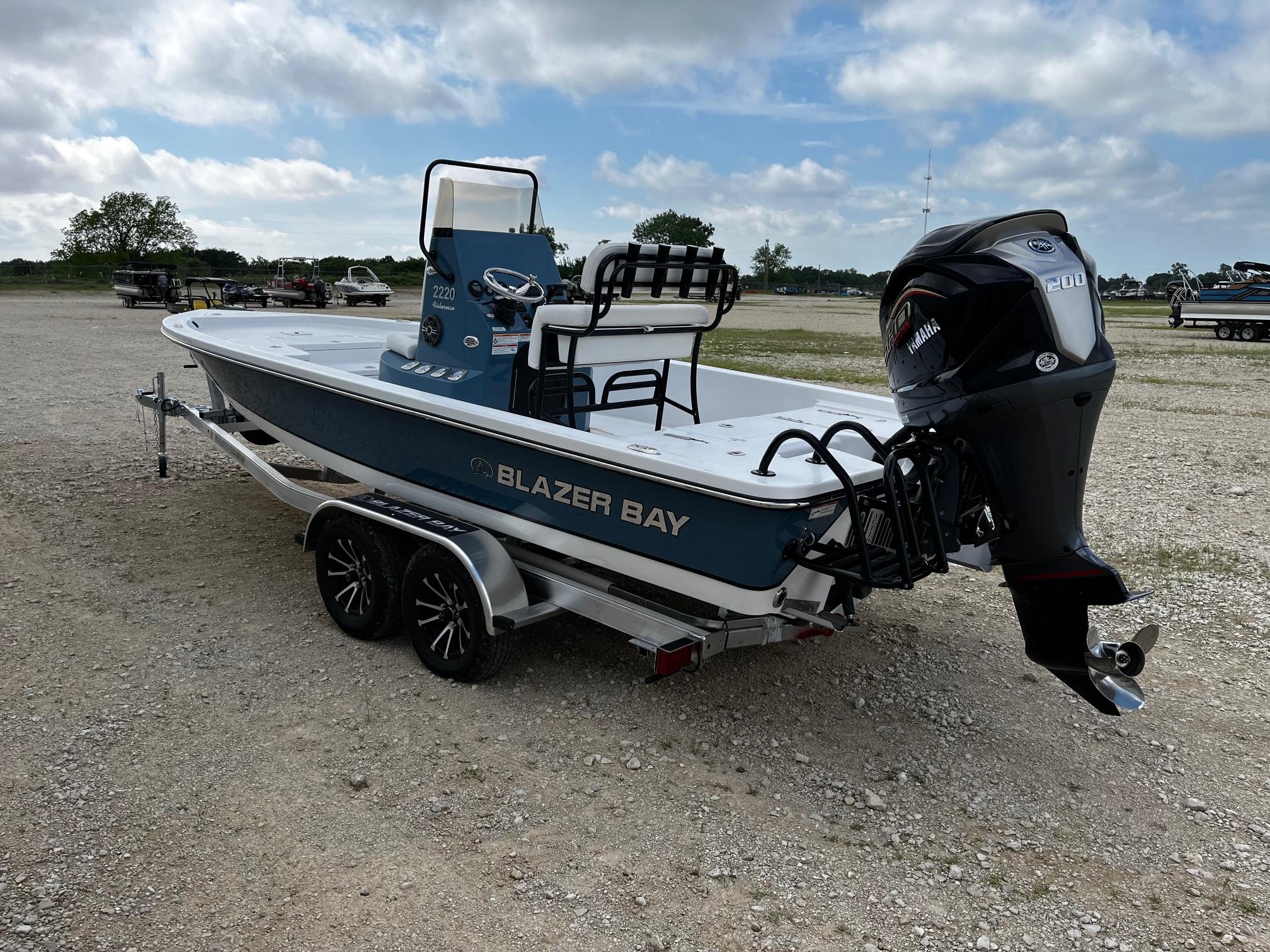 2025 Blazer Bay 2220 Fisherman boat on trailer, parked outdoors under cloudy sky.