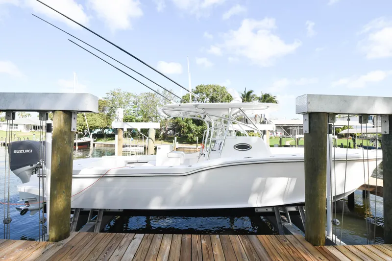  Yacht Photos Pics 2019 Ocean Master 336 Center Console boat docked at a marina.