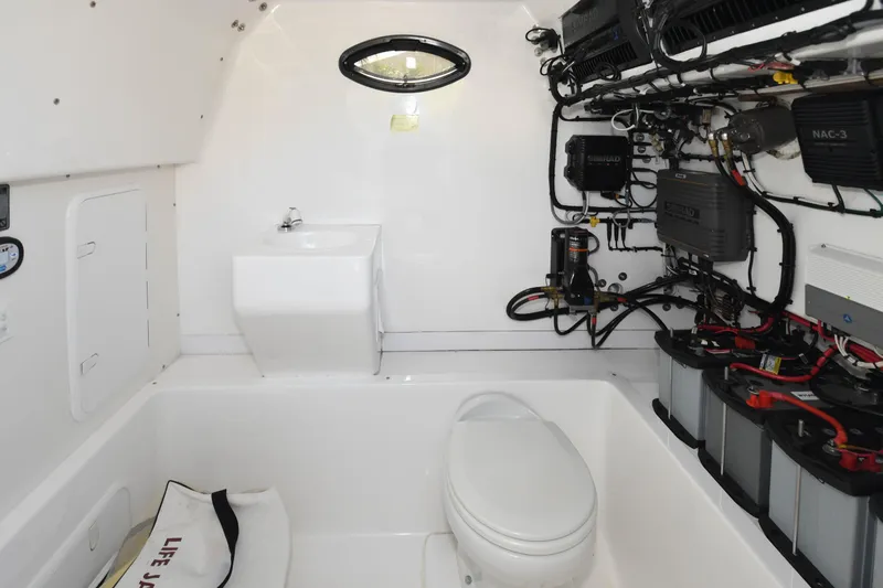  Yacht Photos Pics 2019 Ocean Master 336 Center Console boat interior with toilet and electrical systems.