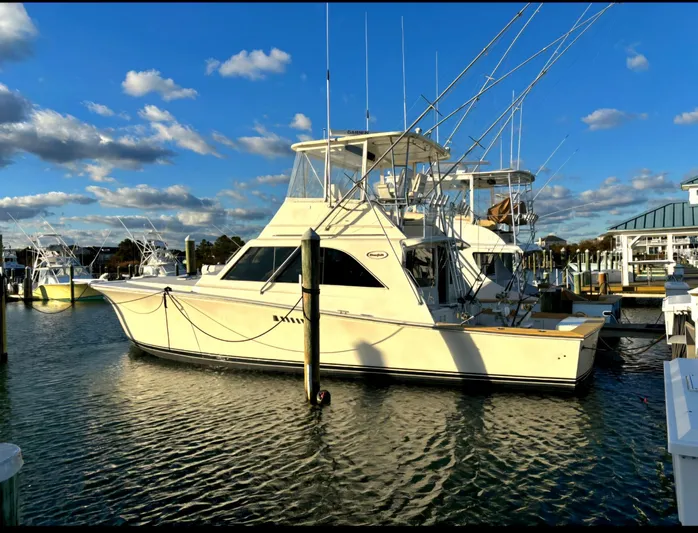 In 2 Deep Yacht Photos Pics 1984 Ocean Yachts 46 Super Sport docked at marina under blue sky.
