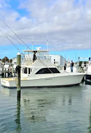 In 2 Deep Yacht Photos Pics 1984 Ocean Yachts 46 Super Sport docked at a marina under a partly cloudy sky.