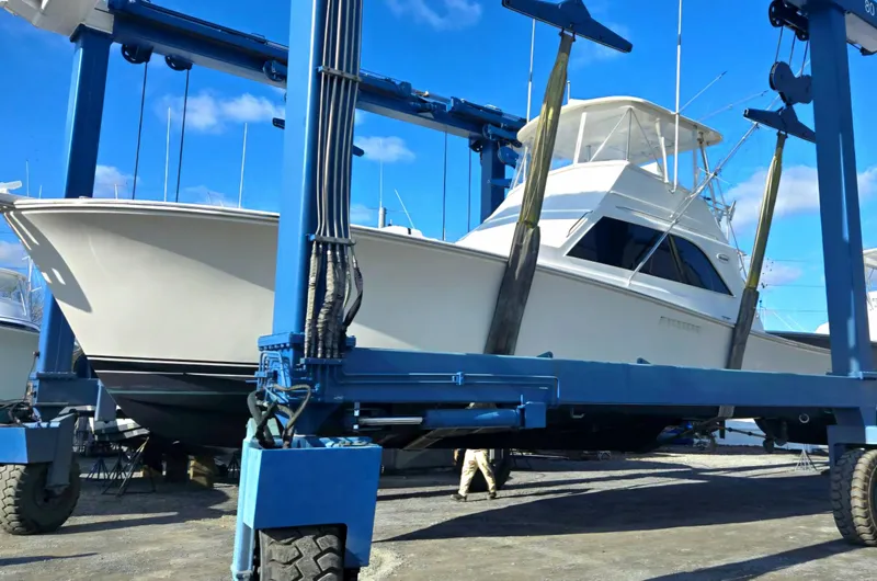 In 2 Deep Yacht Photos Pics 1984 Ocean Yachts 46 Super Sport on a boat lift under clear blue skies.