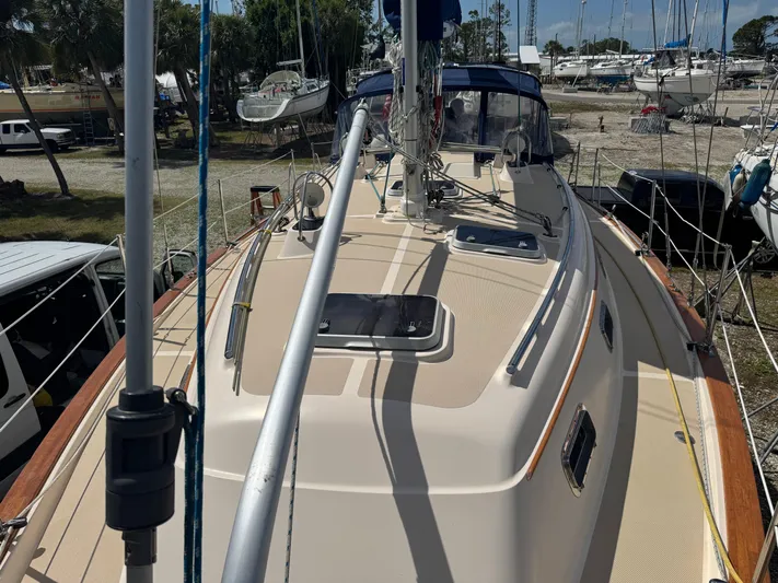 Odyssey Yacht Photos Pics Island Packet 380 sailboat deck, 2002 model, docked in a marina with surrounding boats.