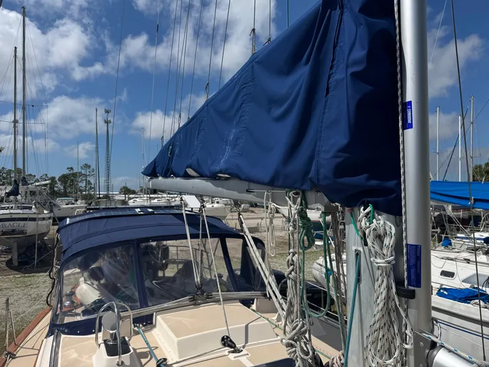 Odyssey Yacht Photos Pics Island Packet 380 sailboat, 2002 model, docked with blue sail cover and clear sky.