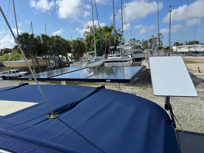 Odyssey Yacht Photos Pics 2002 Island Packet 380 sailboat with solar panels and satellite dish in a marina.