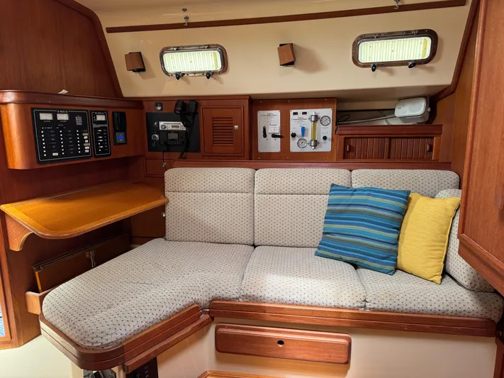 Odyssey Yacht Photos Pics Interior of 2002 Island Packet 380 sailboat with cozy seating and control panels.