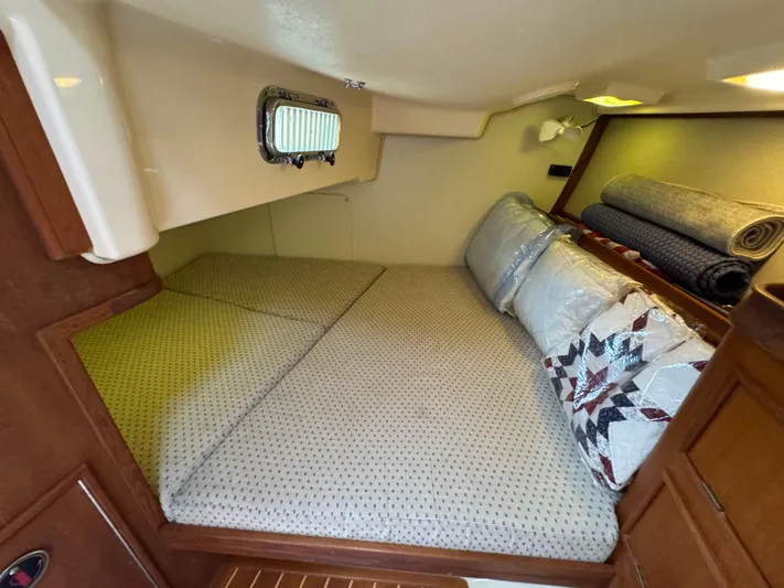 Odyssey Yacht Photos Pics Cozy cabin interior of 2002 Island Packet 380 sailboat with bedding and porthole.
