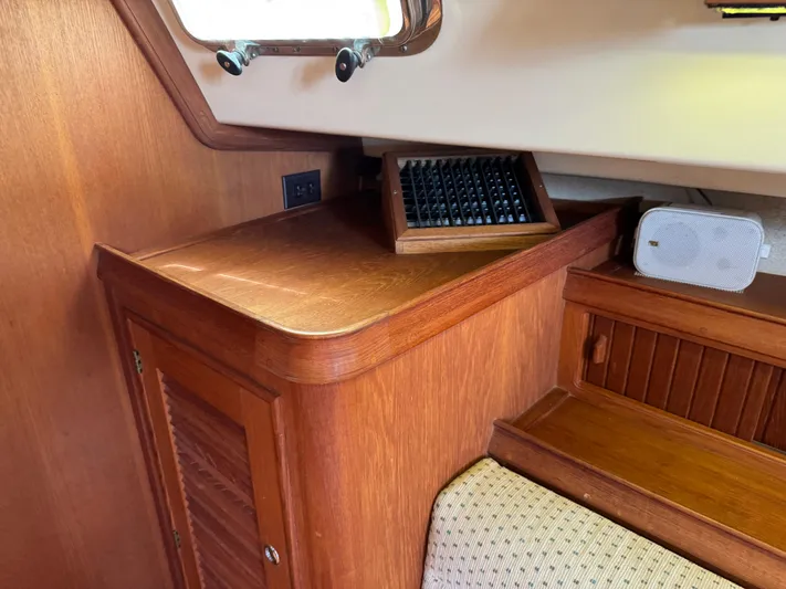 Odyssey Yacht Photos Pics Interior of a 2002 Island Packet 380 sailboat with wooden cabinetry and seating.