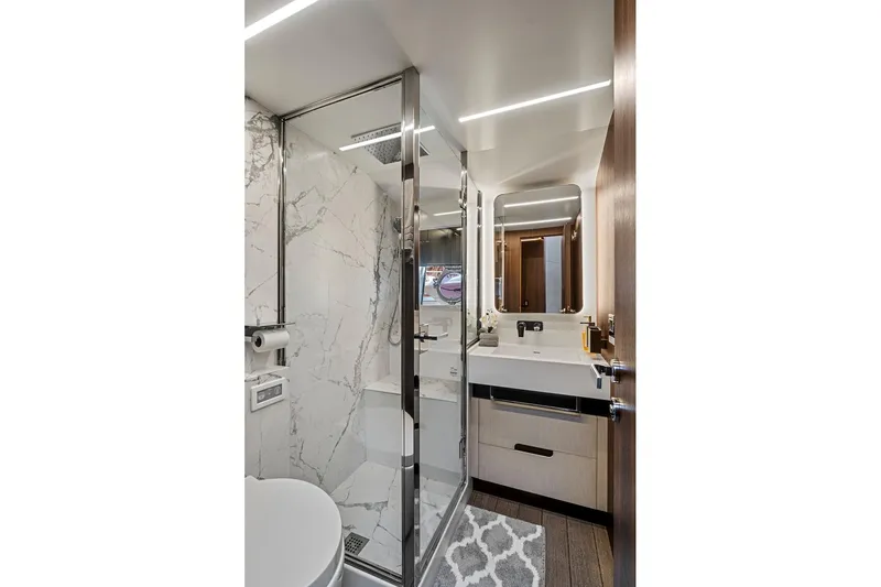 Smile Yacht Photos Pics Luxurious bathroom in 2023 Astondoa 66 Flybridge yacht with modern fixtures and marble accents.
