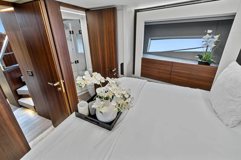 Smile Yacht Photos Pics Luxurious bedroom interior of 2023 Astondoa 66 Flybridge yacht with elegant wood finishes.