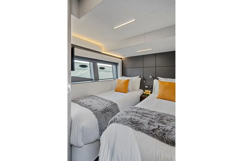 Smile Yacht Photos Pics Luxurious twin bedroom in 2023 Astondoa 66 Flybridge yacht, featuring modern design and cozy decor.