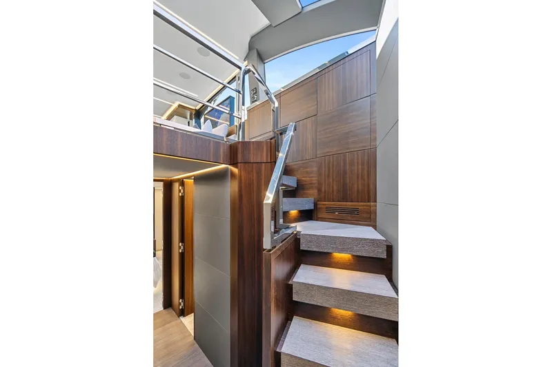 Smile Yacht Photos Pics Luxurious interior staircase of 2023 Astondoa 66 Flybridge yacht with modern wood paneling.